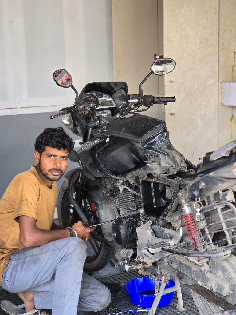 Expert technician debugging mechanical and engine components of a premium motorcycle